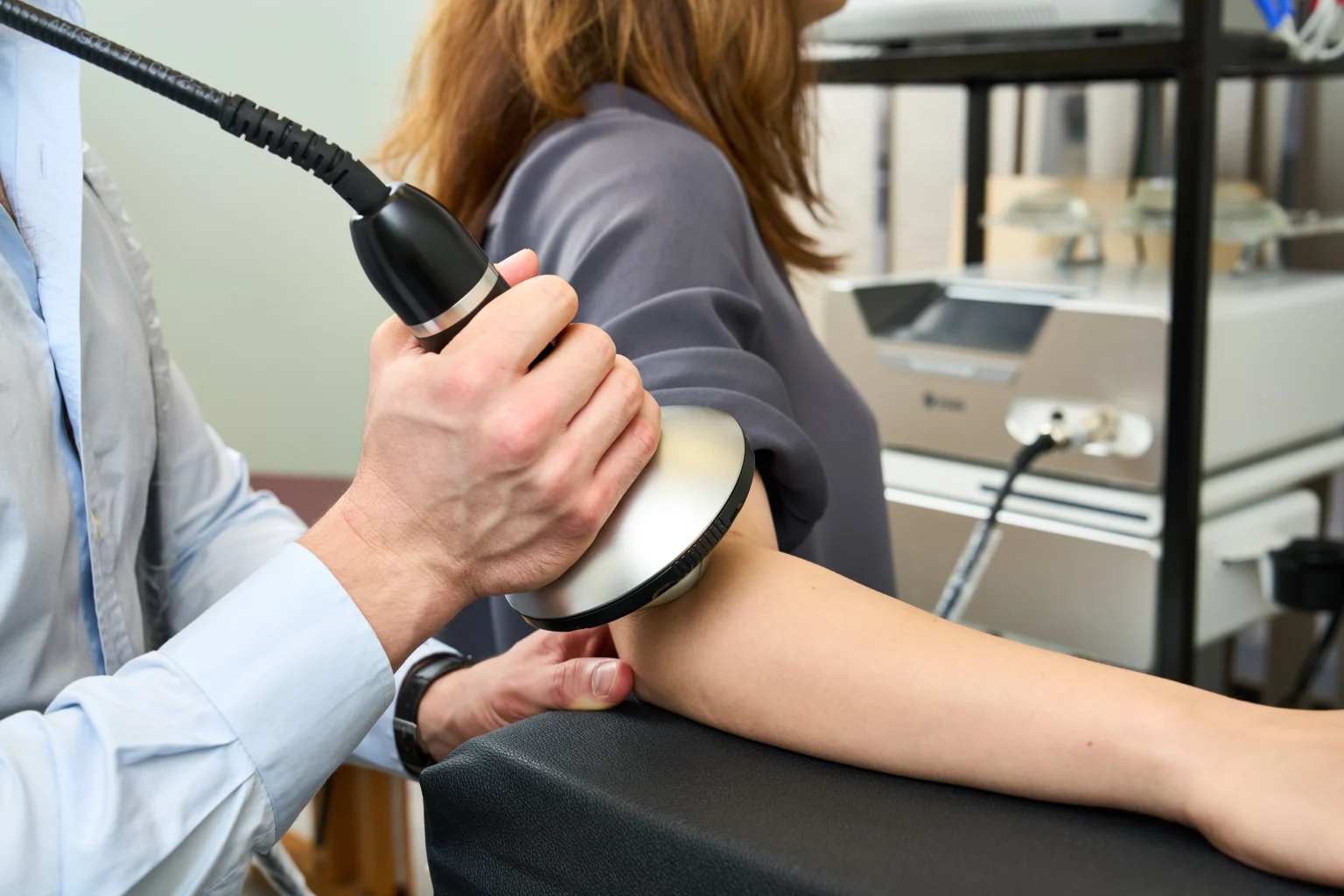 Shockwave therapy applied to a patient's elbow