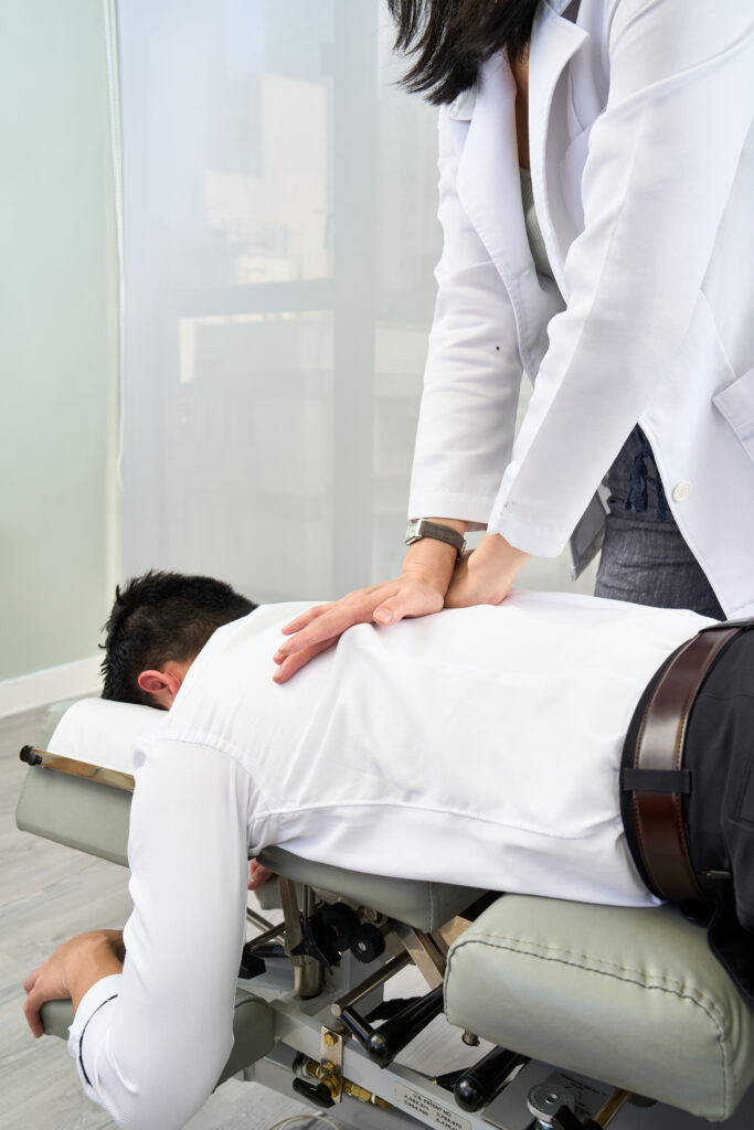 What conditions are treated by flexion distraction therapy